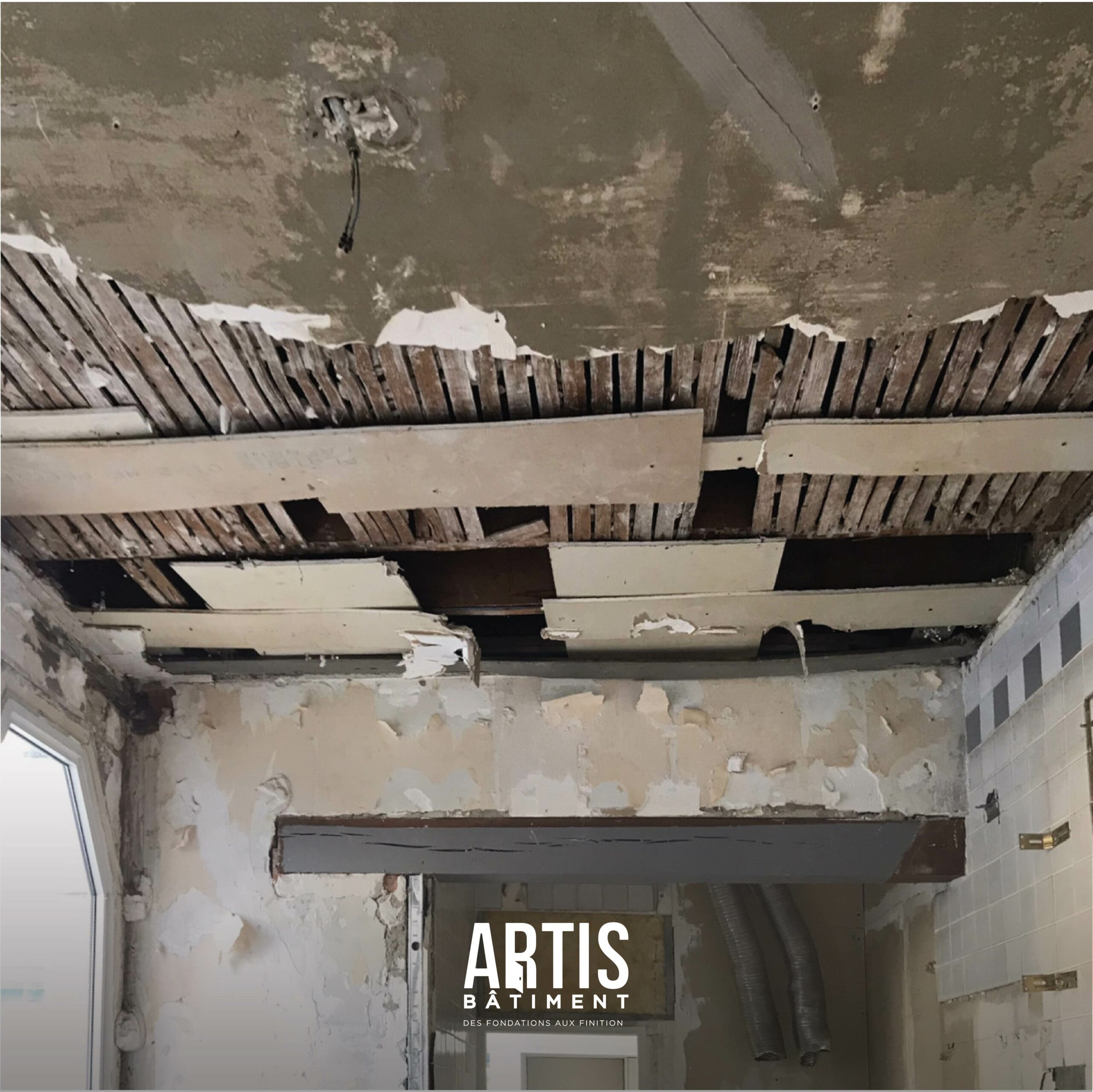 Plafond d’ancienne cuisine démonté avec structure apparente pendant travaux de rénovation.