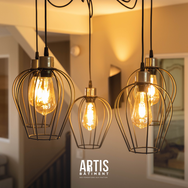 Suspensions lumineuses style industriel avec ampoules apparentes dans une maison rénovée.