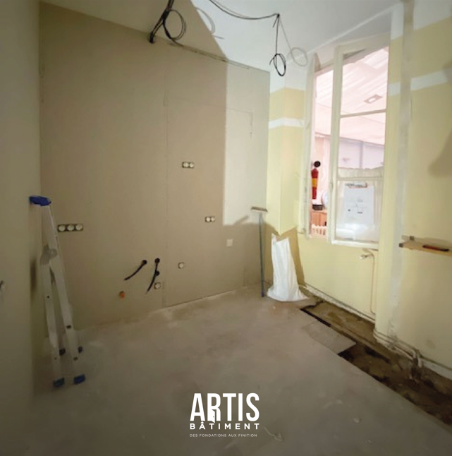 Cuisine avant rénovation avec réseaux apparents et supports en préparation.